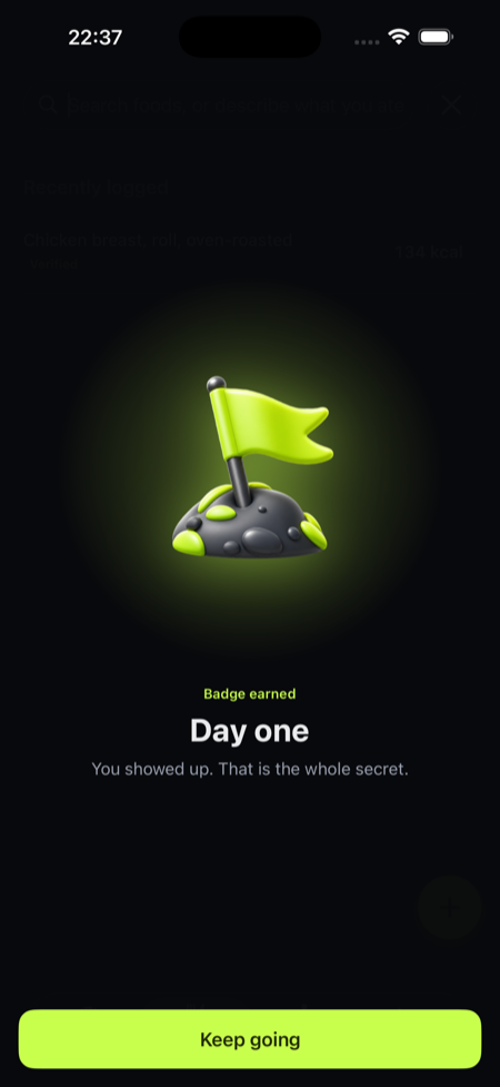 The badge earned moment: a 3D flag badge with Day one and Keep going